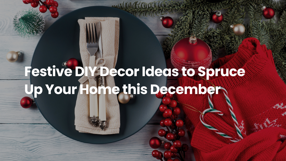 Festive holiday table setting with a dark dinner plate, wrapped cutlery, red ornaments, evergreen branches, and a cozy red sweater, showcasing DIY Christmas home decor ideas.
