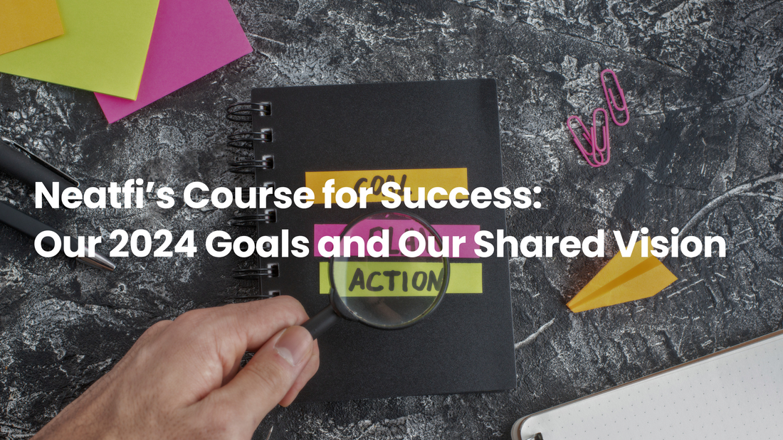 Notebook with colorful goal-setting labels, magnifying glass, sticky notes, and office supplies, representing Neatfi’s 2024 goals, action plans, and shared vision for success.