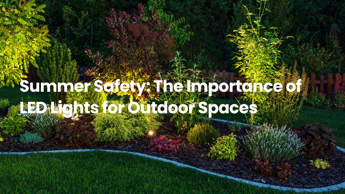 Landscaped outdoor garden at night with LED uplights illuminating trees, shrubs, and flower beds, highlighting the safety benefits of outdoor LED lighting.